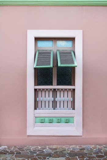 opened white teal and brown wooden louvered window panel