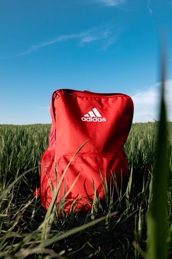 Orange Adidas Backpack On Grass Field