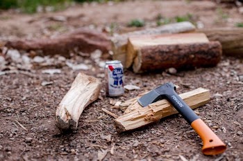 orange and black axe on brown wood