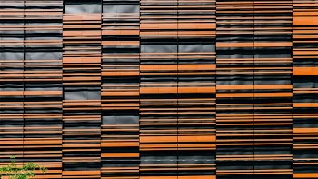 orange and black glass building at daytime