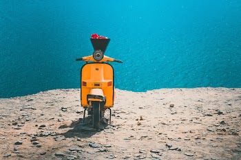 Orange and Black Motorcycle on Brown Sand