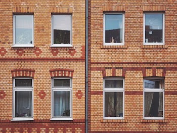 orange and red brick wall with mirrors