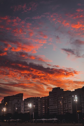 Orange Clouds over City at Sunset