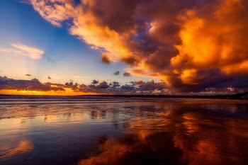 Orange Clouds Reflected on Body of Water