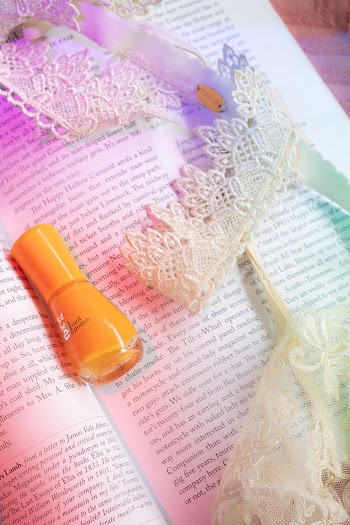 Orange Nail Polish On A Book