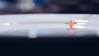 Orange Plastic Toy on White Surface