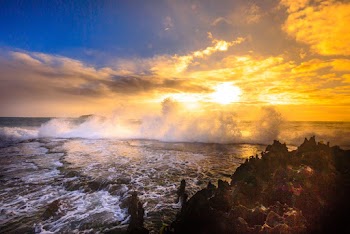 Orange Setting Sun in Horizon over Beach