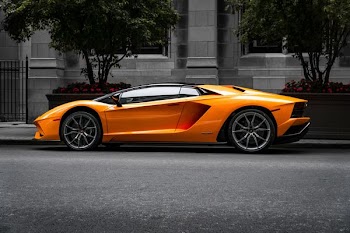 orange sports car on roadway