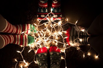 orange string lights surrounded by boots