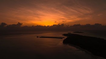 Orange sunset behind Maldives island
