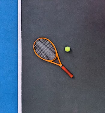 Orange Tennis Racket Beside Green Tennis Ball