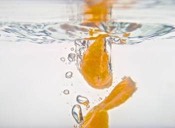 Orange wedges dropping into water (2).jpg