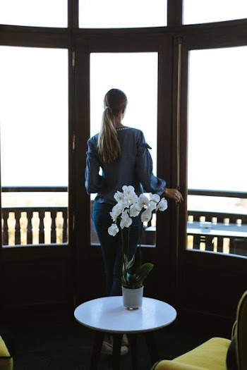 Orchid Decor And Woman Enjoying View