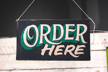 Order Here Text on Black Wooden Board