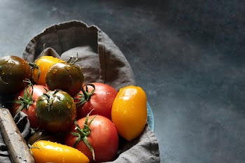 Organic tomatoes vegetable in a sack flat lay