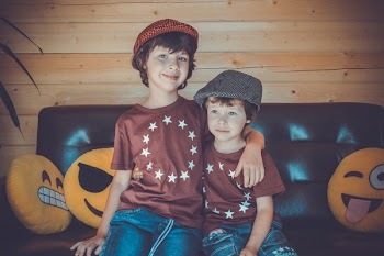 OTwo Boys Sitting on Sofa
