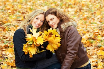 outdoor portrait of two young women in autumnal park