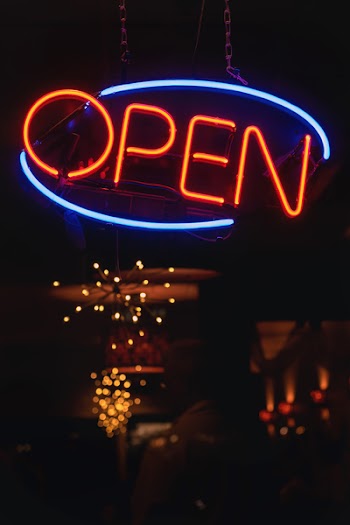 Oval Blue and Orange Open Neon Signage Turned-on