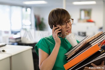 Overwhelmed businesswoman multitasking in office