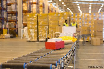 Packages on conveyor belt in distribution warehouse