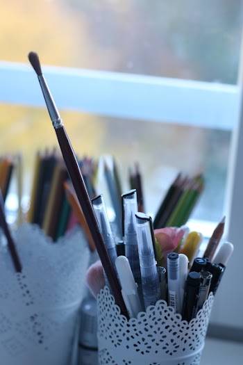 Paint Brush And Pens On White Container