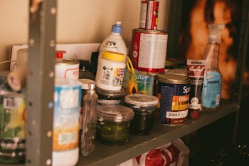 Paint Buckets on Grey Wooden Rack