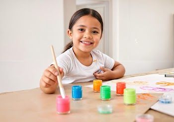 Painting is a game all kids love to play. Shot of an adorable little girl painting while sitting at a table.