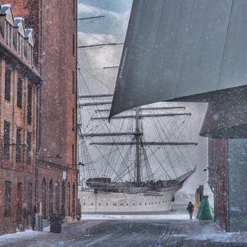 Painting of Man Standing Near White Sailing Ship