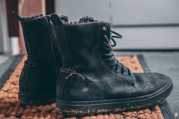 Pair of Black Lace-up Boots on Area Rug