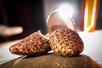 Pair of Brown Flat Shoes on Brown Surface