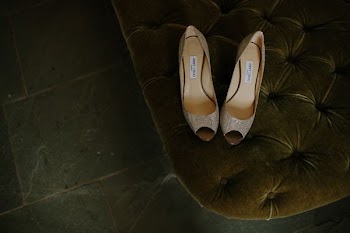 pair of brown gray leather open-toe heeled shoes on tufted mattress
