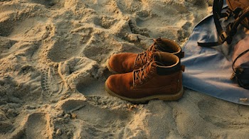 Pair of Brown Work Boots on Sand