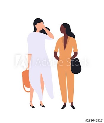 Pair of cute young stylish women standing and talking to each other