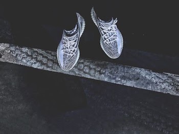 pair of gray-and-black adidas Yeezy Boost 350's