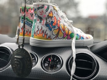 Pair of Multicolored Mid-rise Shoes on Black Car Air Vents