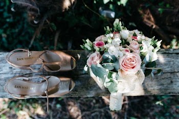 pair of shoes besides flower bouquet