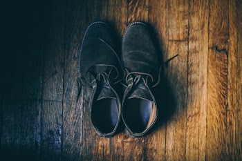 pair of shoes on parquet floor