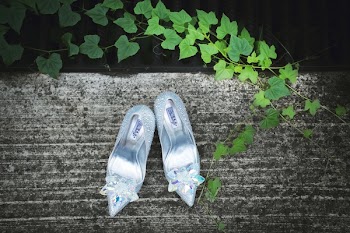 Pair of Silver Pointed-toe Heeled Sandals on Gray Surface