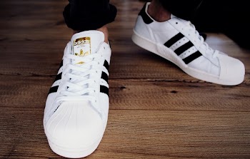 Pair of White-and-black Adidas Superstars