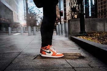 Pair of White-and-orange Nike Sneakers