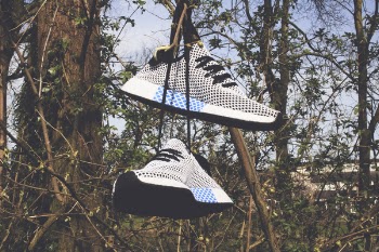 Pair of White Low-top Shoes Hanging on Tree