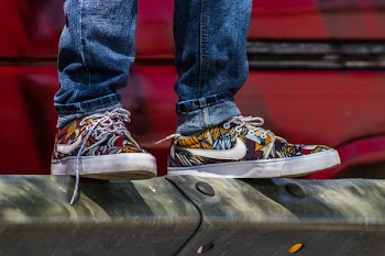 Pair of Yellow-and-red Nike Low-top Sneakers