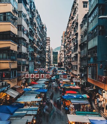 panning photograph of people walking between street stores