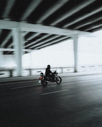 Panning Photography of Man Riding a Motorcycle
