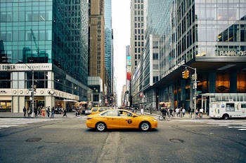 panning photography of tax between buildings