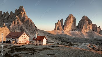 Panorama of Dreizinnen Hut and Tre Cime at sunset, Dolomites