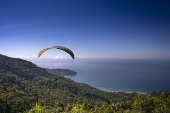 Parachuting Man Above Mountain