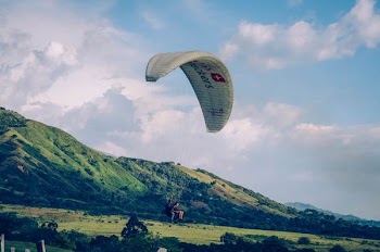 paraglider under blue sky