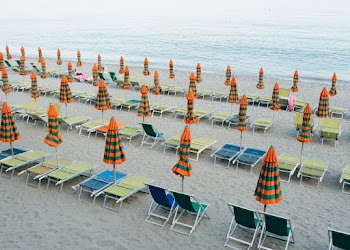 Parasols and Beach Chairs on Sand Near Sea