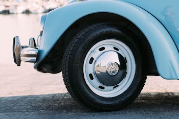 parked blue Volkswagen Beetle